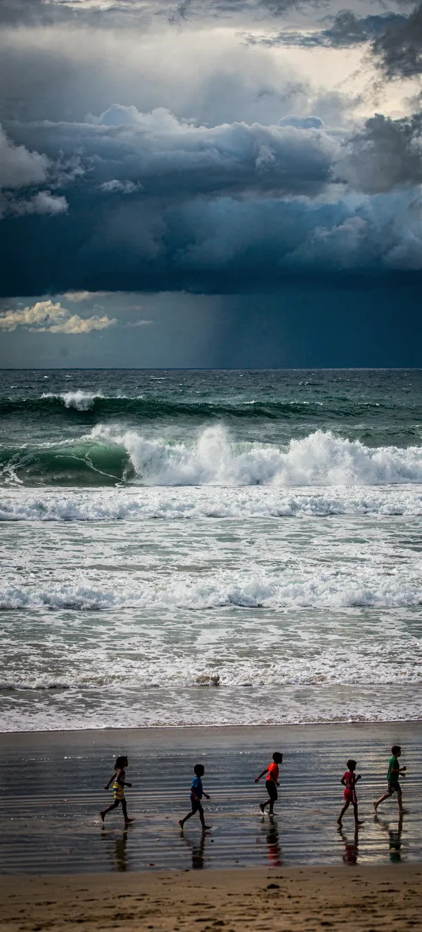 Children Running Beach Stormy Ocean